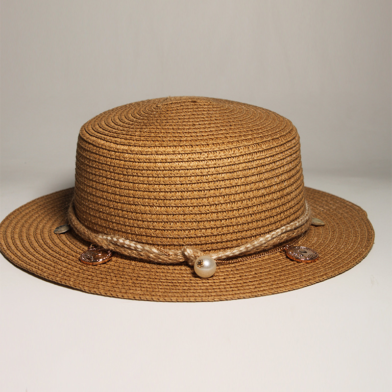 New style round-top straw hat with polka dot ribbon and pearl trim, perfect for beach outings.