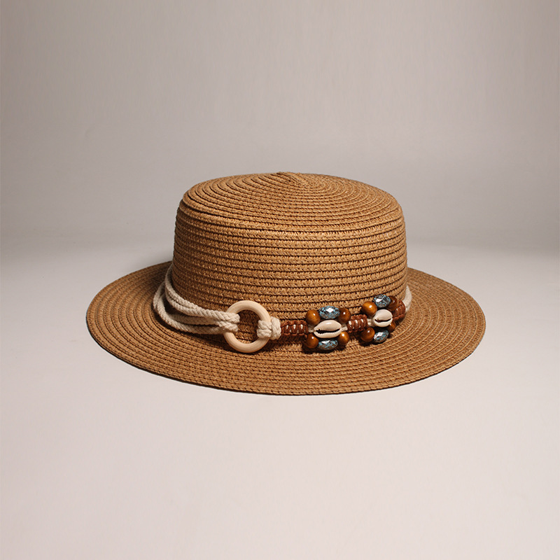 New style round-top straw hat with polka dot ribbon and pearl trim, perfect for beach outings.