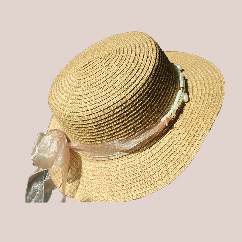 New style round-top straw hat with polka dot ribbon and pearl trim, perfect for beach outings.