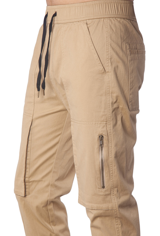Close-up of metal zipper pocket on black slim-fit joggers for secure phone storage