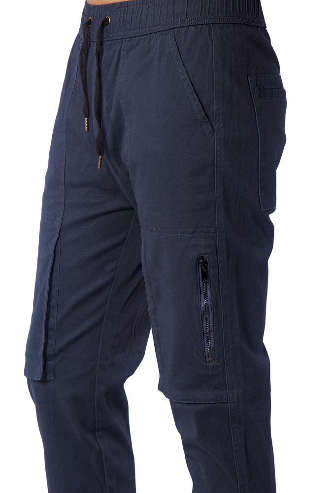Close-up of metal zipper pocket on black slim-fit joggers for secure phone storage