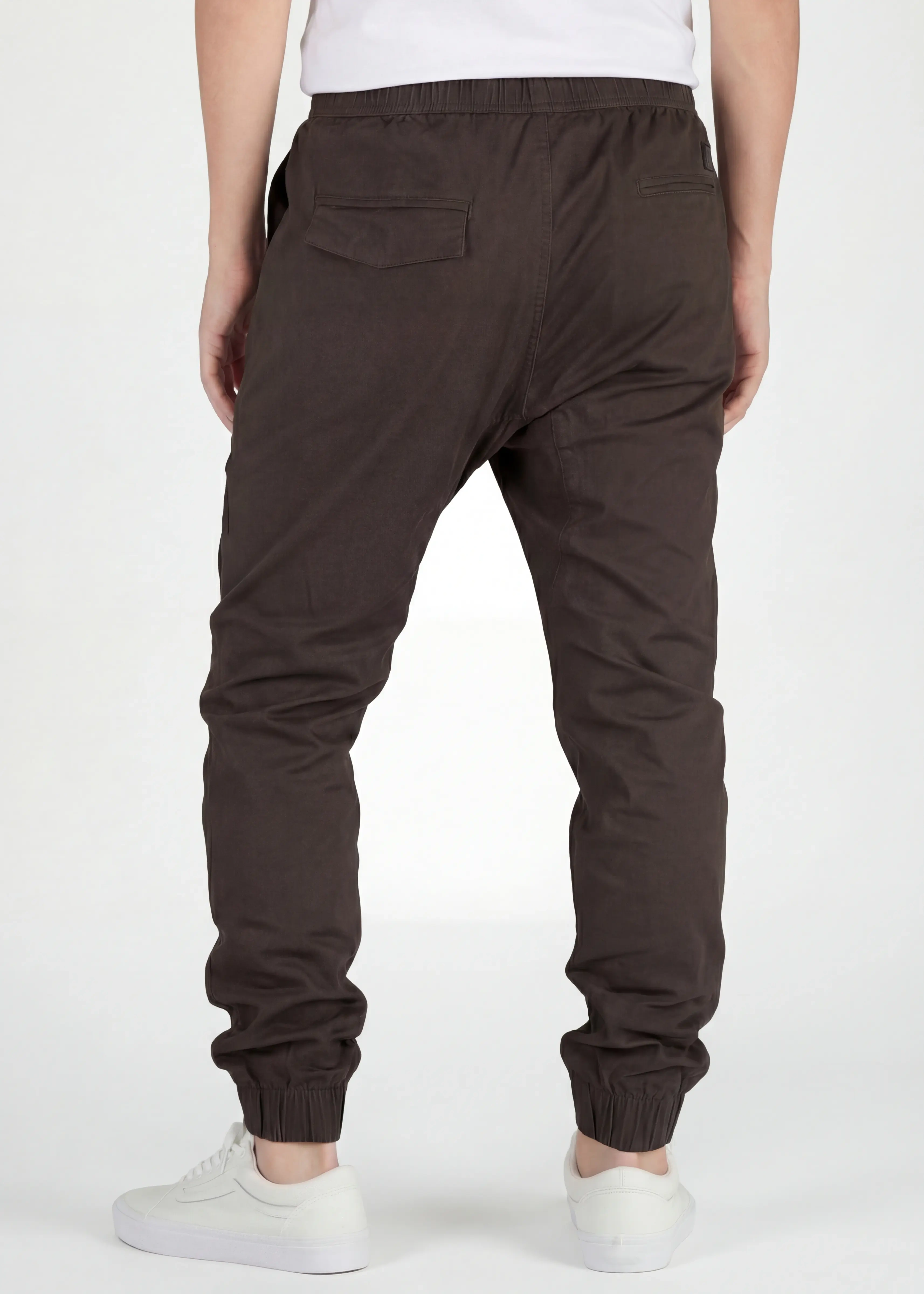 Back view of ItalyMorn men's coffee brown jogger pants on a model, highlighting the secure back pockets, well-fitted seat, and comfortable ribbed ankle cuffs.