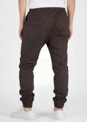 Back view of ItalyMorn men's coffee brown jogger pants on a model, highlighting the secure back pockets, well-fitted seat, and comfortable ribbed ankle cuffs.