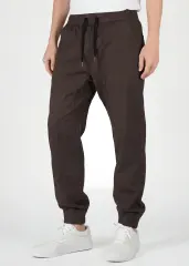  Front close-up of ItalyMorn men's coffee brown jogger pants, featuring an adjustable elastic waistband with black drawstrings, deep functional side pockets, and a clean tailored look.