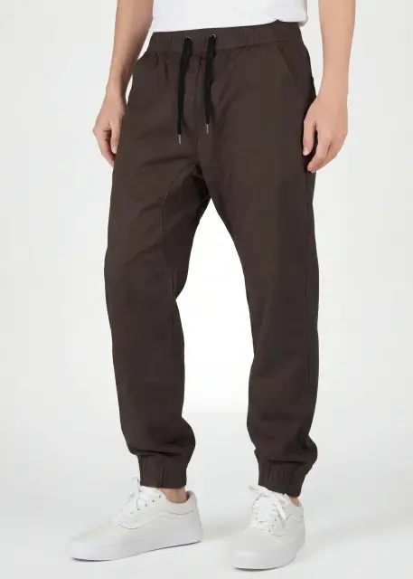  Front close-up of ItalyMorn men's coffee brown jogger pants, featuring an adjustable elastic waistband with black drawstrings, deep functional side pockets, and a clean tailored look.