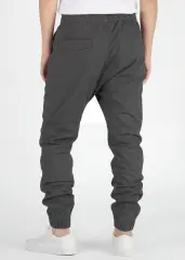 Back view of ItalyMorn men's dark grey jogger pants on a model, showcasing the secure back pockets, well-tailored seat, and snug ribbed ankle cuffs