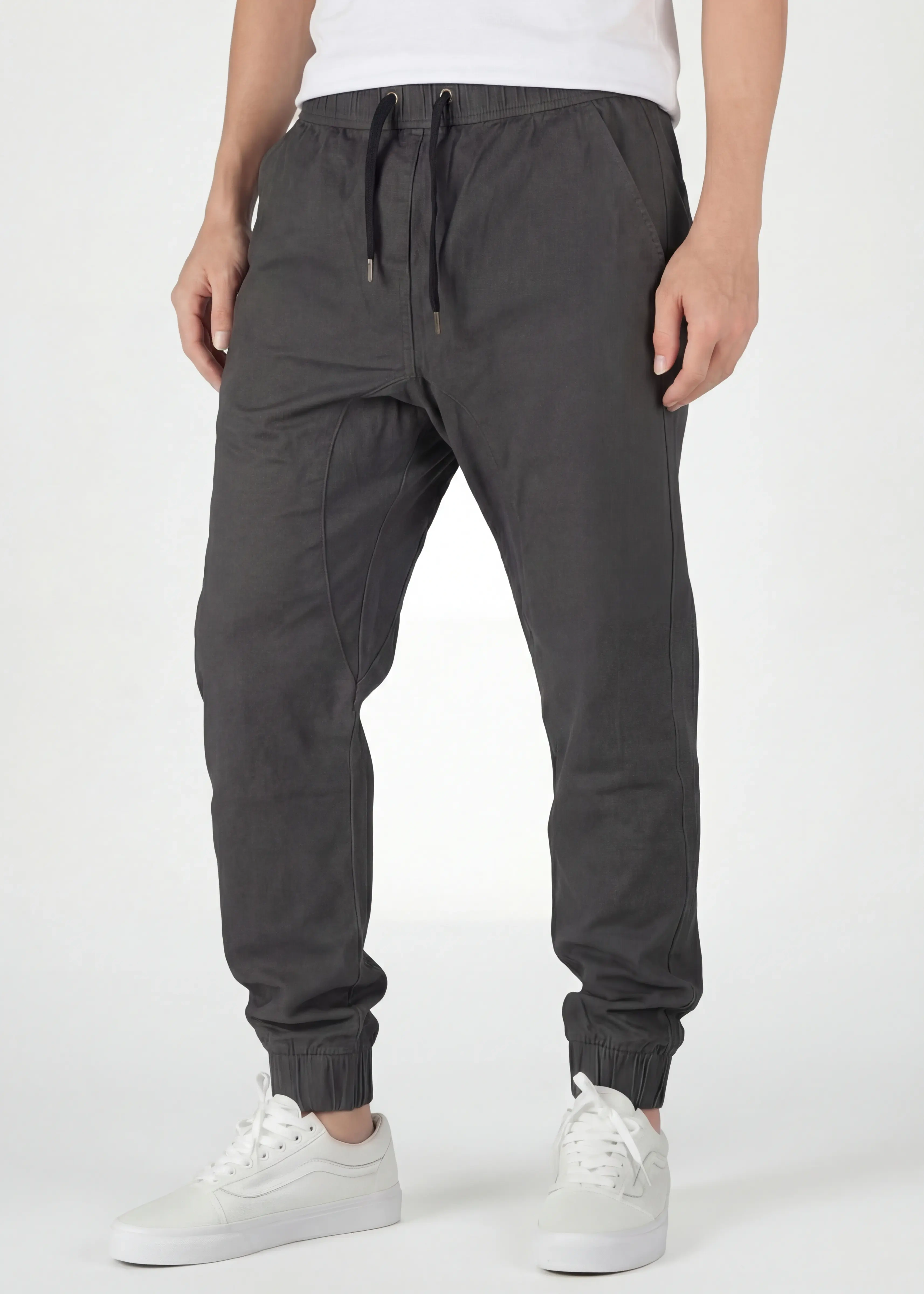  Front view detail of ItalyMorn men's dark grey jogger pants, featuring a comfortable elastic waistband with black drawstrings, deep angled side pockets, and a clean, slim-tapered fit