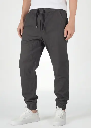  Front view detail of ItalyMorn men's dark grey jogger pants, featuring a comfortable elastic waistband with black drawstrings, deep angled side pockets, and a clean, slim-tapered fit