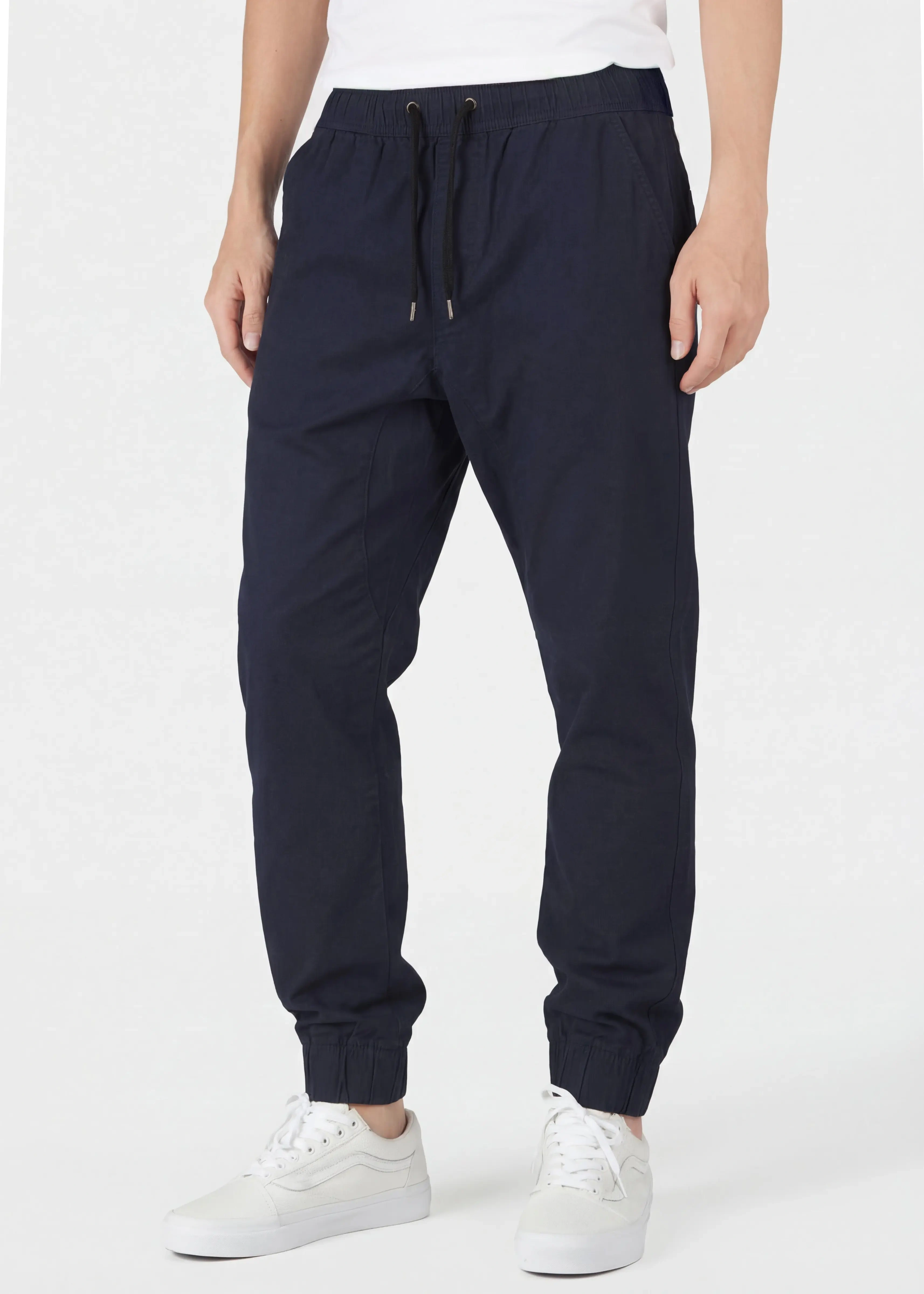 Close-up front view of ItalyMorn men's navy blue jogger pants, highlighting the comfortable elastic waistband with drawstrings, practical side pockets, and slim-tapered silhouette