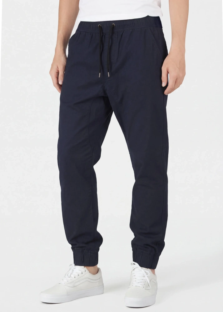 Close-up front view of ItalyMorn men's navy blue jogger pants, highlighting the comfortable elastic waistband with drawstrings, practical side pockets, and slim-tapered silhouette