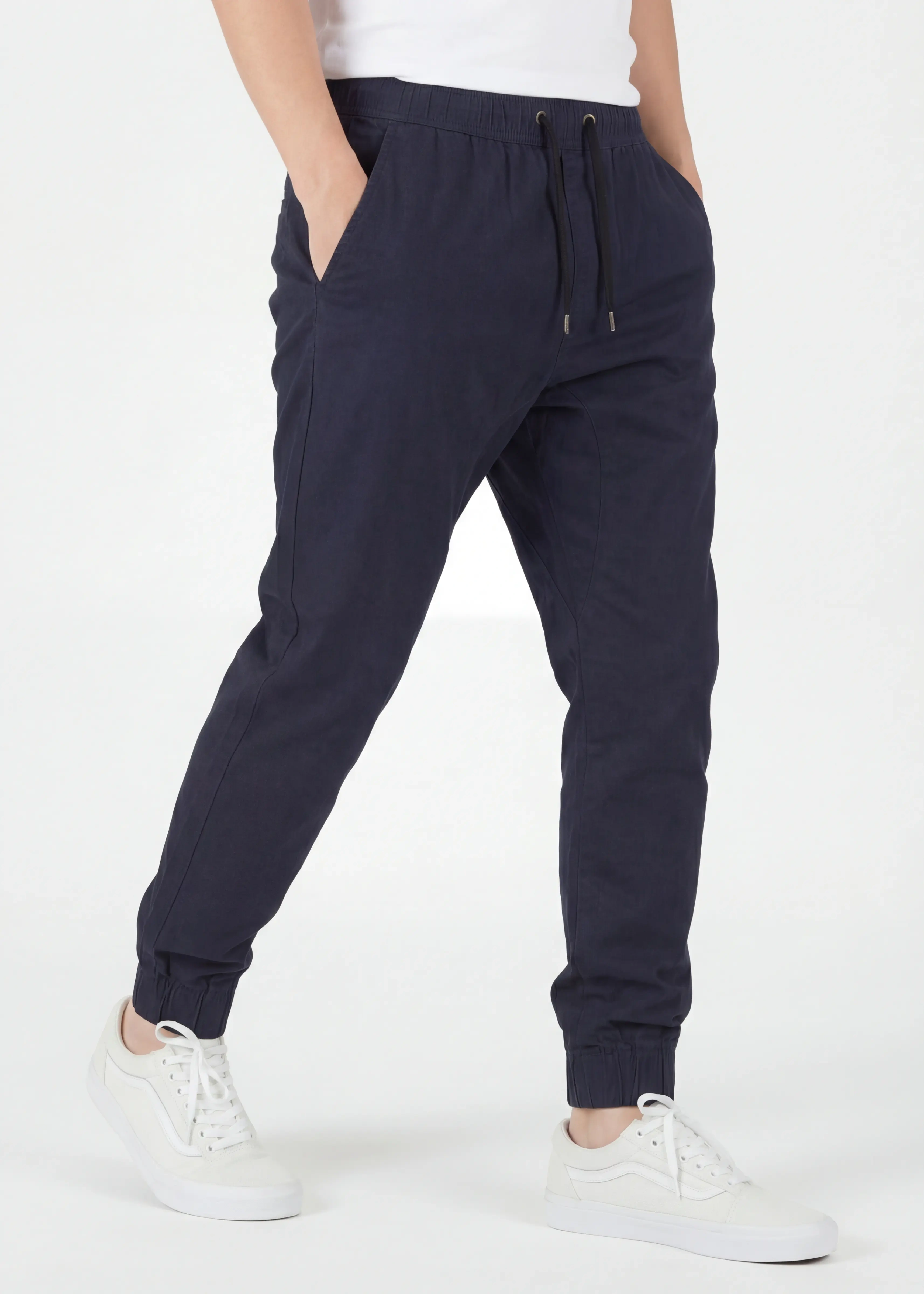 Angled front view of ItalyMorn men's navy blue jogger pants with hands in pockets, emphasizing the relaxed yet tailored fit and the smooth drape of the premium cotton-blend fabric