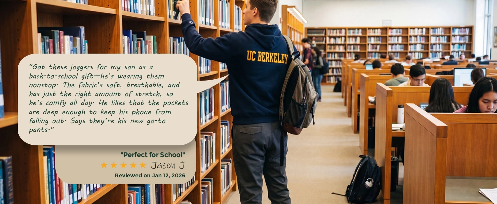 A young man browsing books in a library wearing a university hoodie and ItalyMorn charcoal classic joggers. A customer review overlay praises the pants as perfect for school, highlighting their breathable fabric and secure deep pockets.