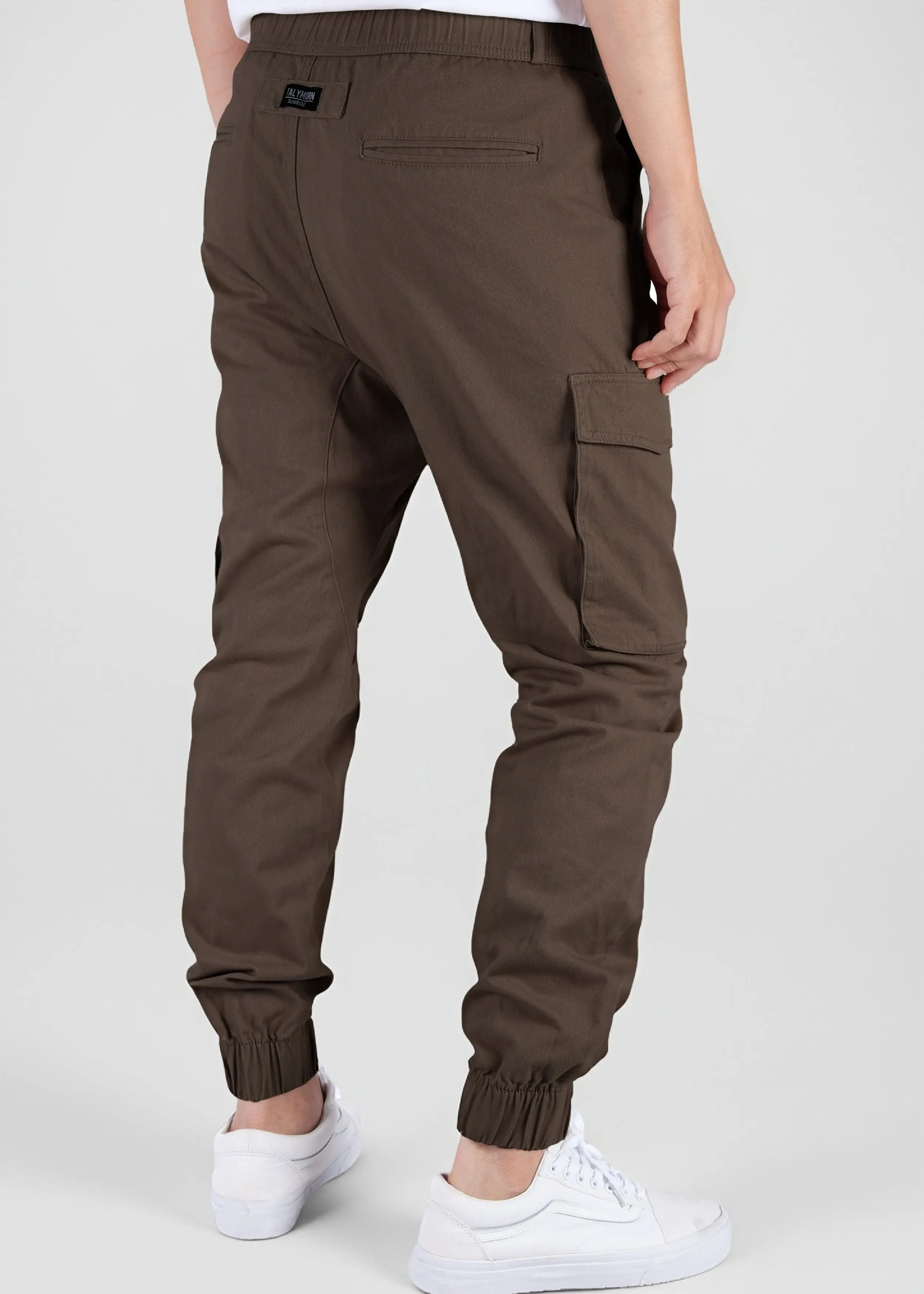 Back view of a male model wearing men's dark brown cargo joggers, showcasing the comfortable elastic waistband, back welt pockets with the ITALYMORN woven brand label, and side cargo pockets.