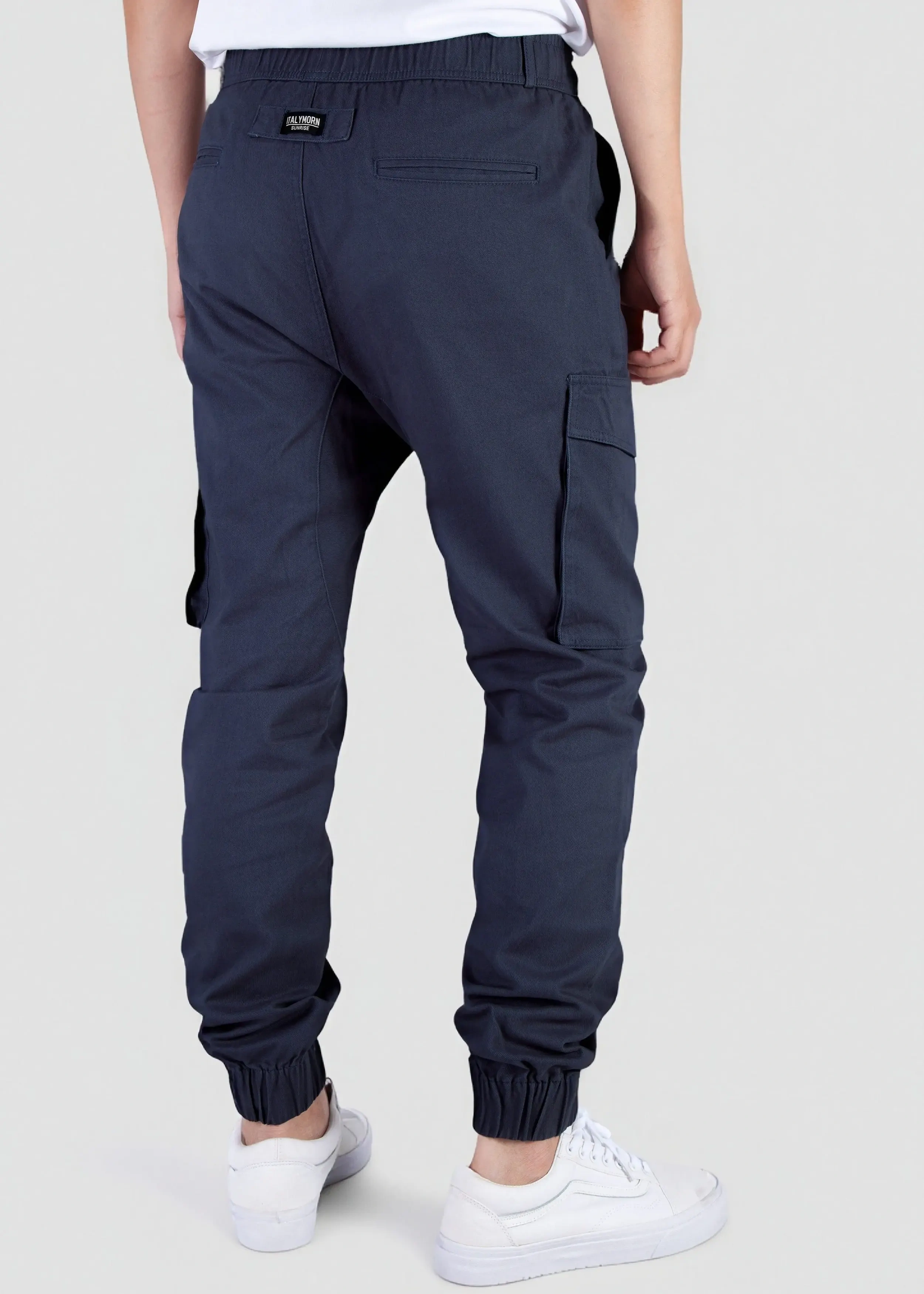Back view of a male model wearing men's navy blue cargo joggers, showcasing the comfortable elastic waistband, back welt pockets with the ITALYMORN woven brand label, and side cargo pockets.