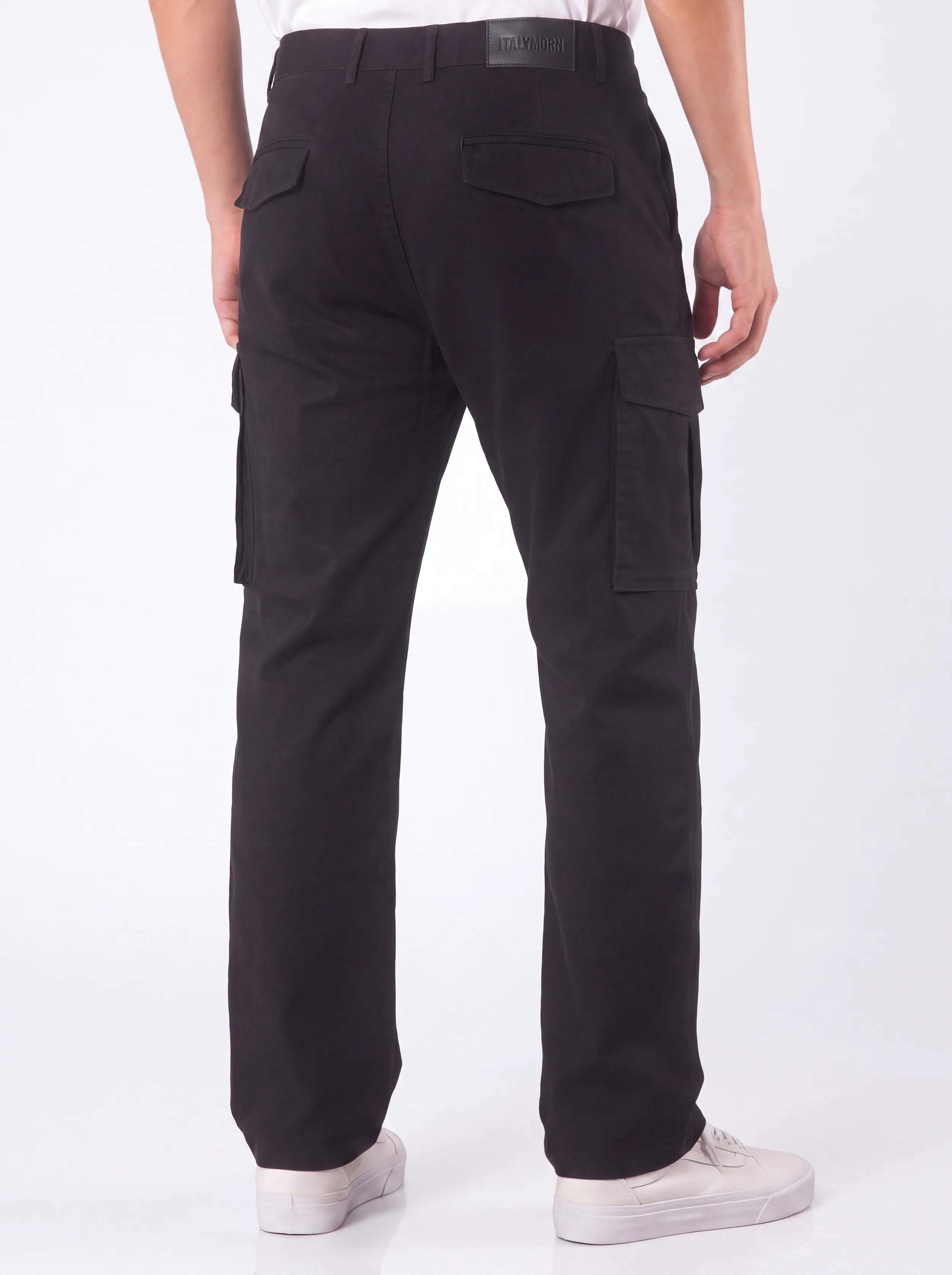 Back view of a male model wearing men's black cargo pants, showcasing a tailored fit, secure flap back pockets with the ITALYMORN brand patch, and a reinforced waistband.