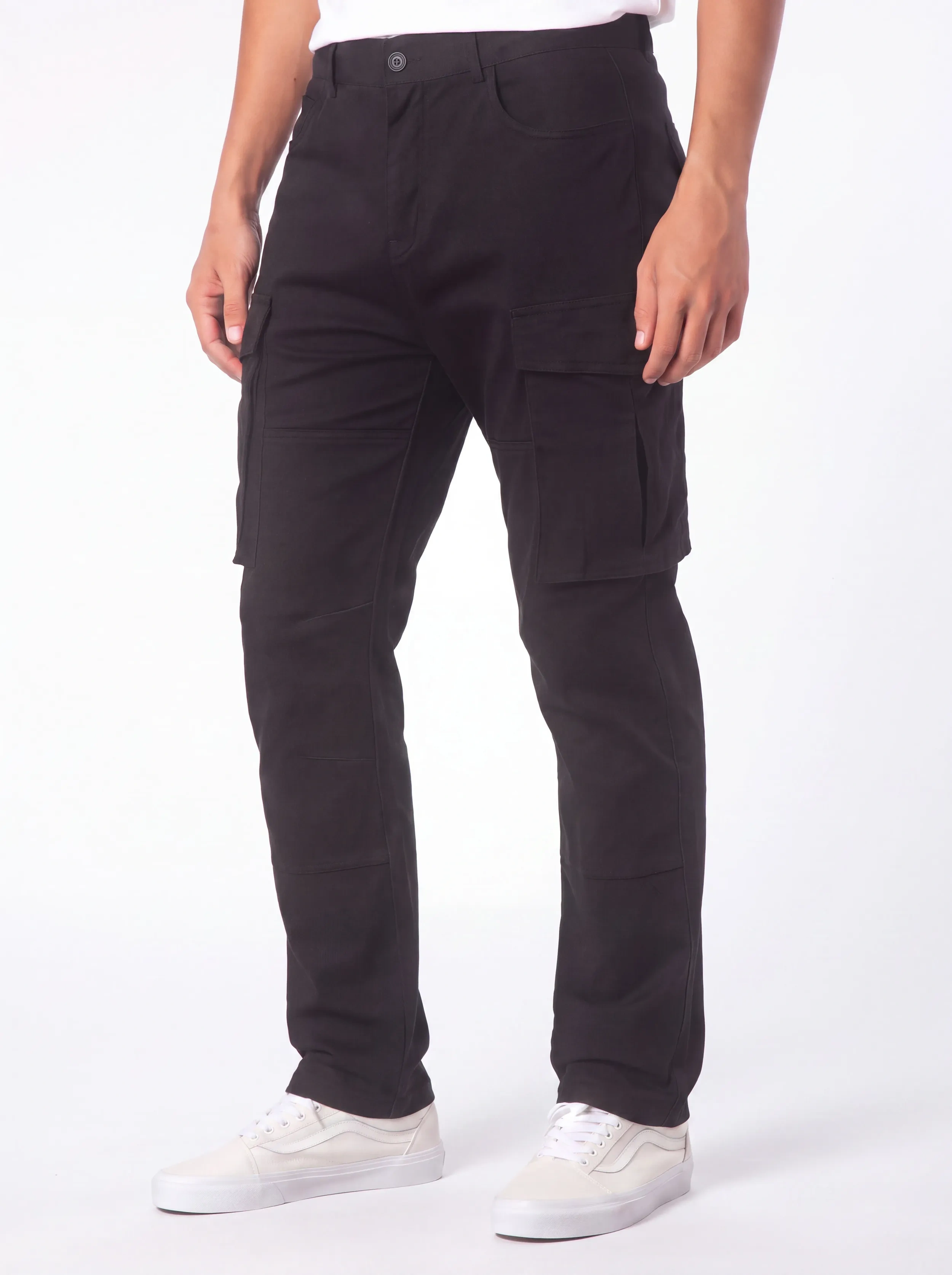 Front view of a male model wearing ITALYMORN men's black cargo pants, featuring a classic button closure, deep front pockets, and functional side cargo pockets, paired with white sneakers.
