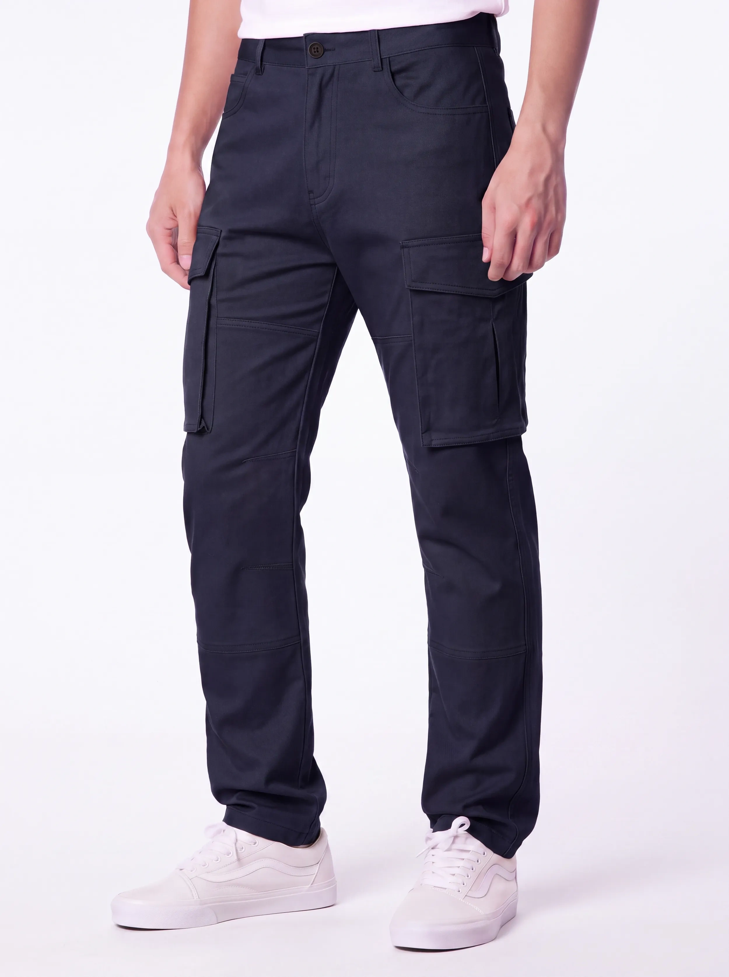 Front view of a male model wearing ITALYMORN men's dark blue cargo pants, featuring a classic button closure, deep front pockets, and functional side cargo pockets, paired with white sneakers.