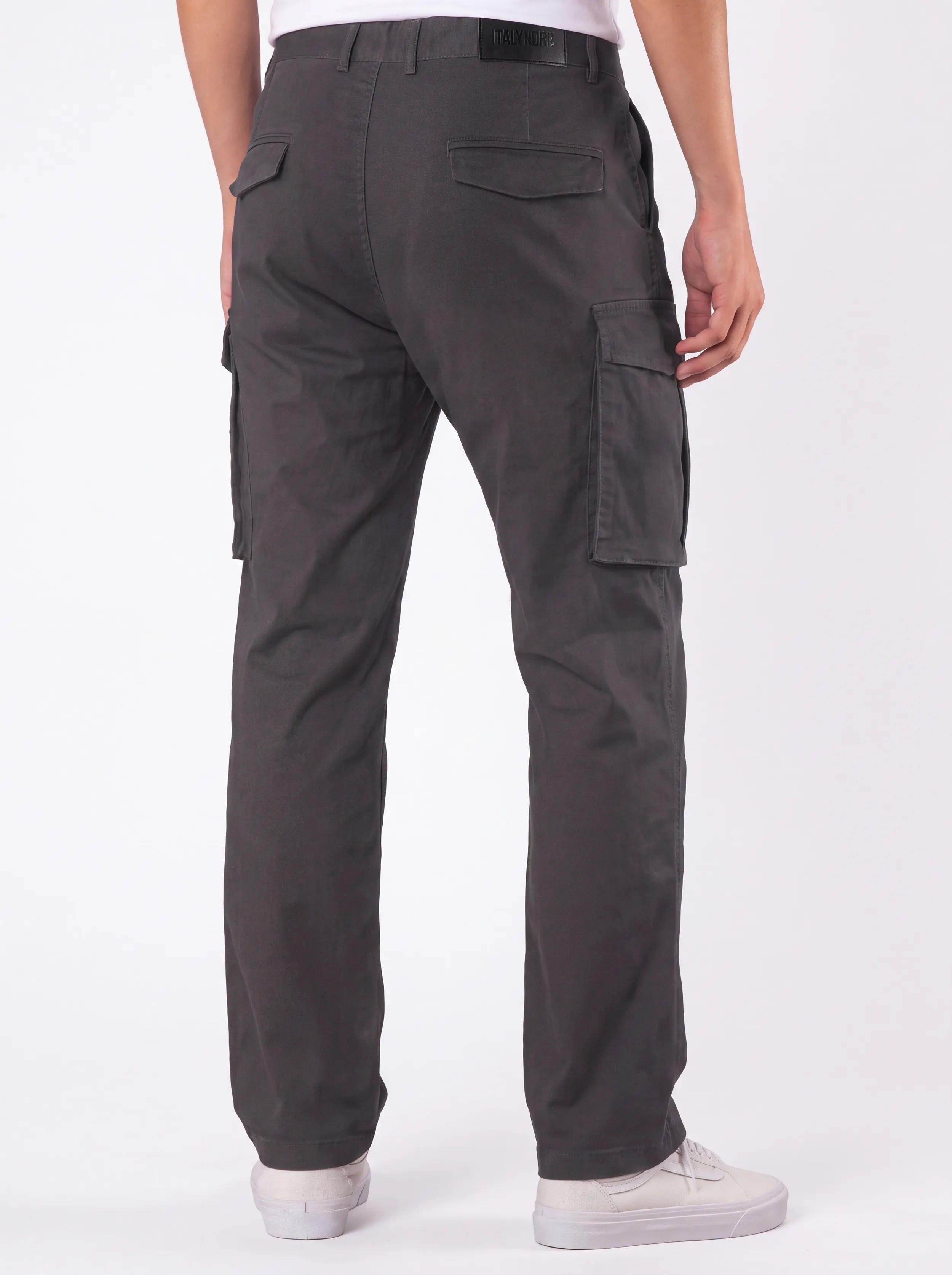Back view of a male model wearing men's dark grey cargo pants, showcasing a tailored fit, secure flap back pockets with the ITALYMORN brand patch, and a reinforced waistband.