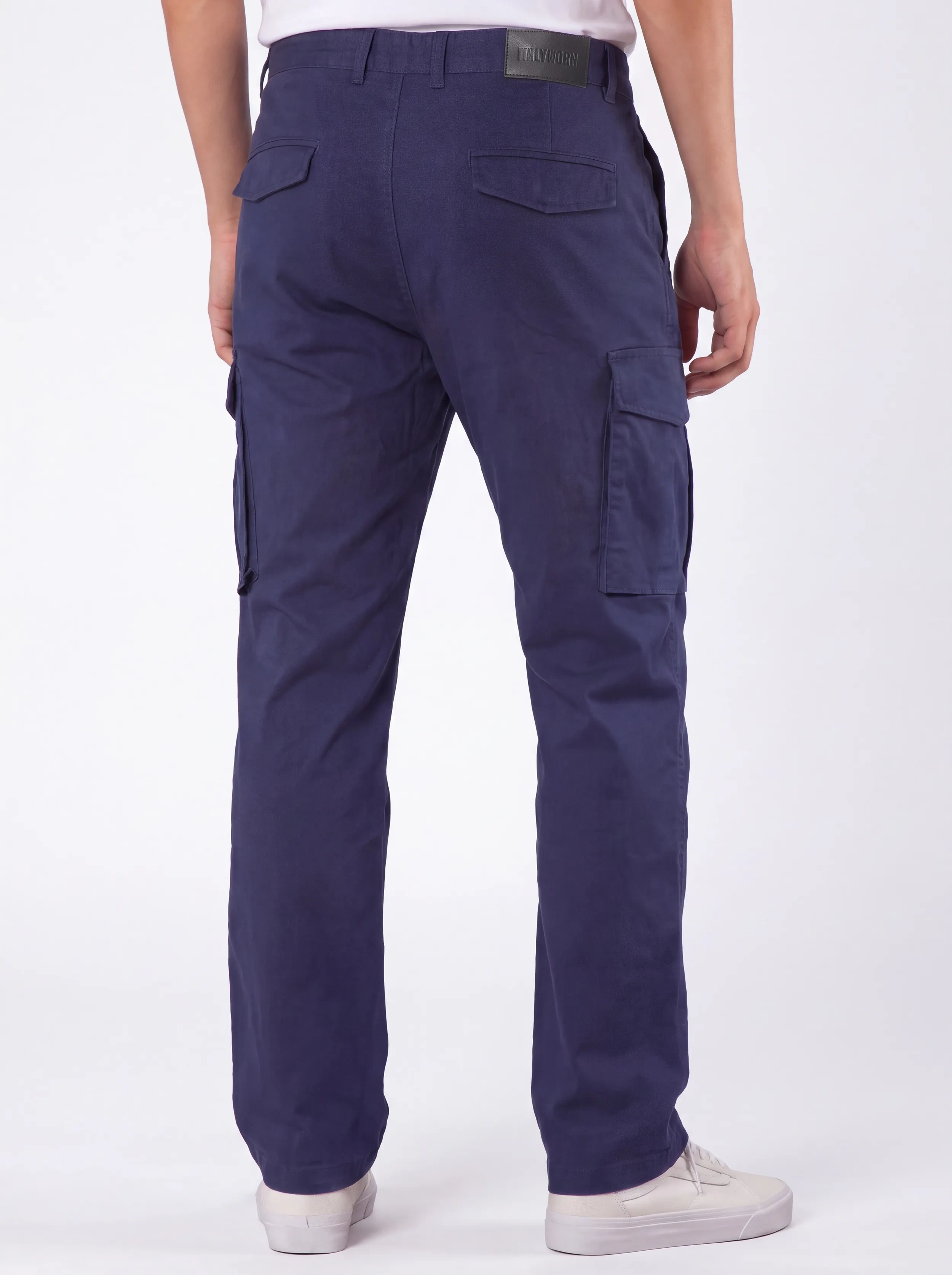 Back view of a male model wearing men's navy blue cargo pants, showcasing a tailored fit, secure flap back pockets with the ITALYMORN brand patch, and a reinforced waistband.