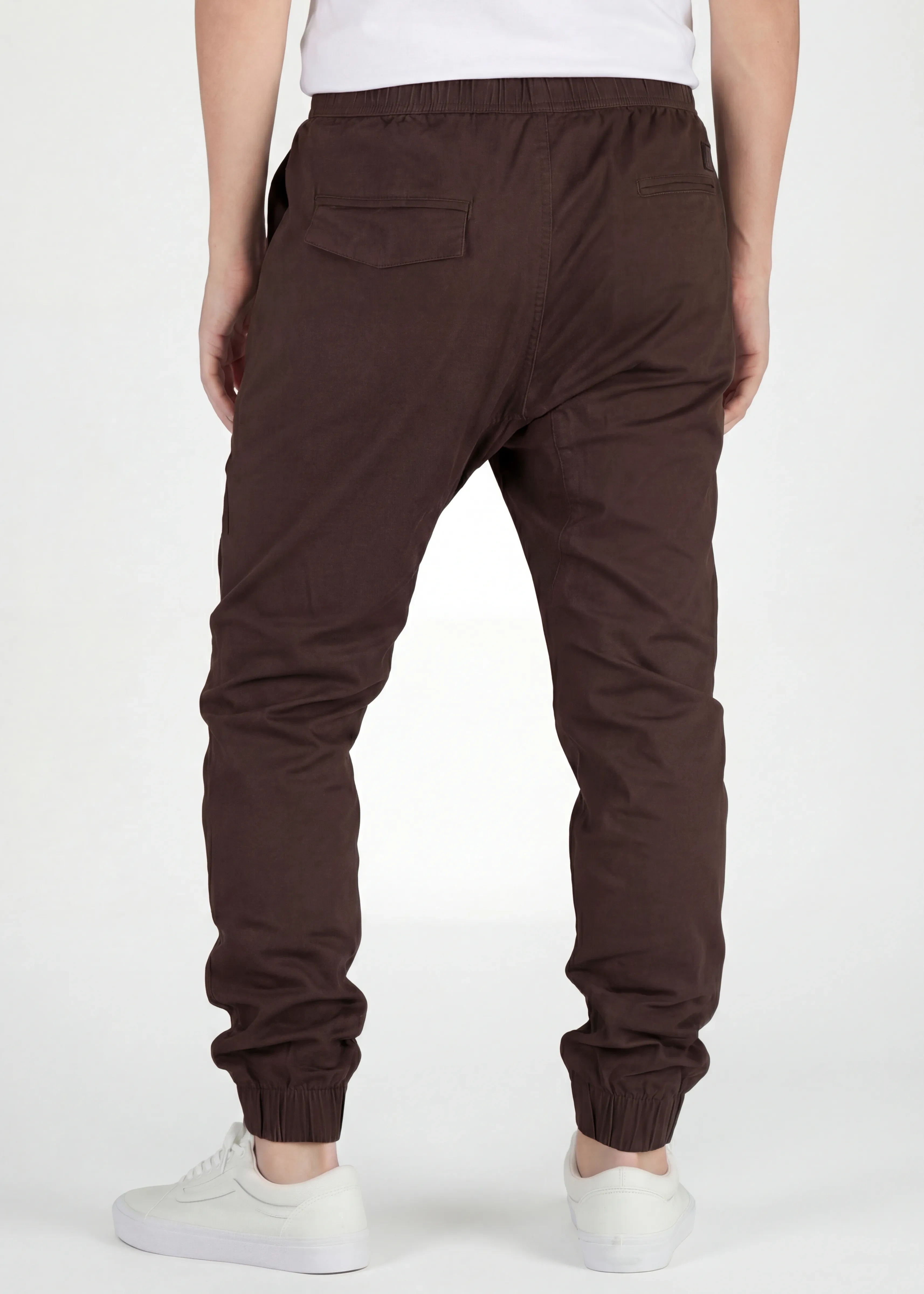 Back view of ItalyMorn men's coffee brown jogger pants on a model, highlighting the secure back pockets, well-fitted seat, and comfortable ribbed ankle cuffs.