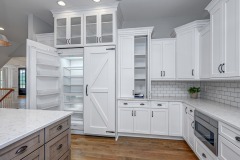 Unionlands Cabinetry White Painting Hidden Fridge Cabinet With Black Walnut Solid Wood Island and a Special Range Hood