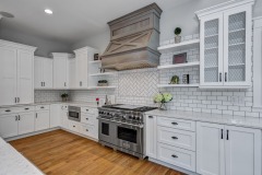Unionlands Cabinetry White Painting Hidden Fridge Cabinet With Black Walnut Solid Wood Island and a Special Range Hood