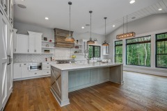 Unionlands Cabinetry White Painting Hidden Fridge Cabinet With Black Walnut Solid Wood Island and a Special Range Hood