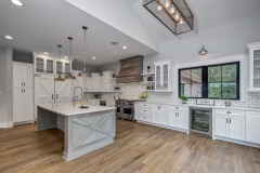Unionlands Cabinetry White Painting Hidden Fridge Cabinet With Black Walnut Solid Wood Island and a Special Range Hood