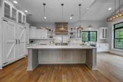 Unionlands Cabinetry White Painting Hidden Fridge Cabinet With Black Walnut Solid Wood Island and a Special Range Hood