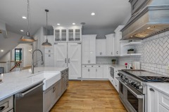 Unionlands Cabinetry White Painting Hidden Fridge Cabinet With Black Walnut Solid Wood Island and a Special Range Hood