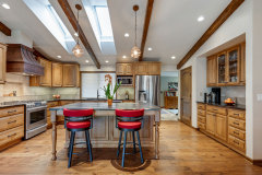 Unionlands Cabinetry Raised Panel Stain Hickory Solid Wood With Sintered Stone Countertop Island and Glass Wink Rack