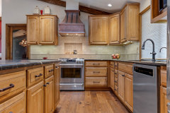 Unionlands Cabinetry Raised Panel Stain Hickory Solid Wood With Sintered Stone Countertop Island and Glass Wink Rack