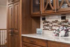 Unionlands Cabinetry Raised Panel Cherry Stain and Mullion Glass Door With White Painted Island Cabinet
