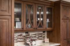 Unionlands Cabinetry Raised Panel Cherry Stain and Mullion Glass Door With White Painted Island Cabinet