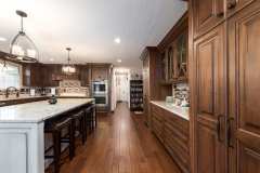 Unionlands Cabinetry Raised Panel Cherry Stain and Mullion Glass Door With White Painted Island Cabinet