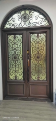 Double panel wrought iron front entry door with arc top in brown color