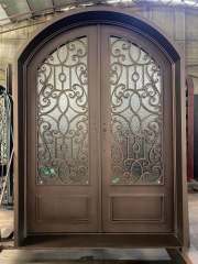 Double panel wrought iron front entry door with arc top in brown color
