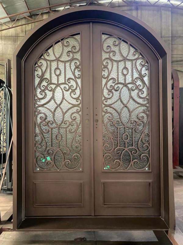 Double panel wrought iron front entry door with arc top in brown color