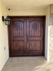 Double panel wrought iron front entry door with arc top in brown color