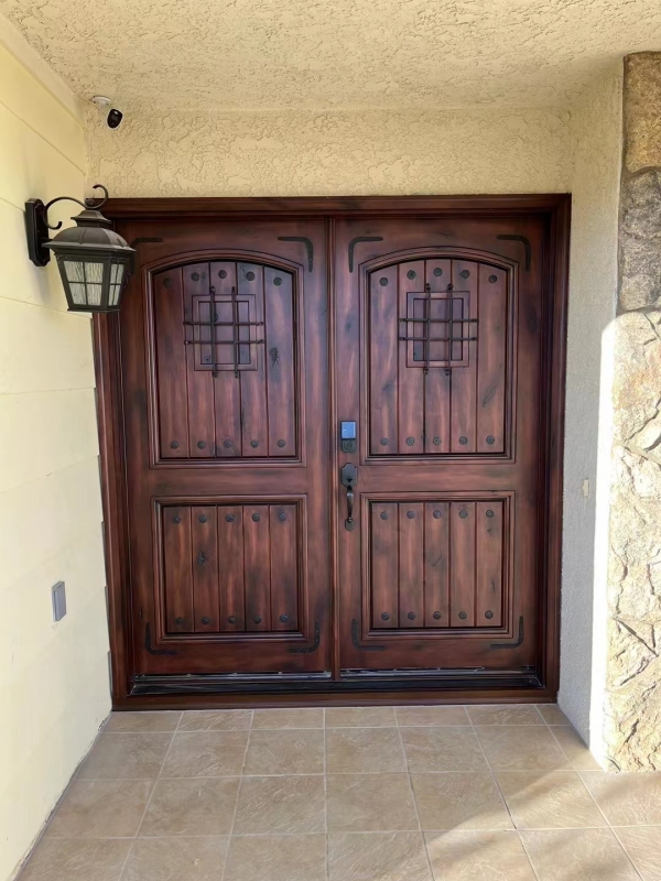 Double panel wrought iron front entry door with arc top in brown color