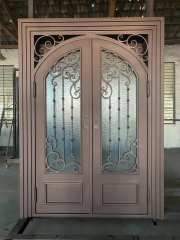 Double panel wrought iron front entry door with arc top in brown color