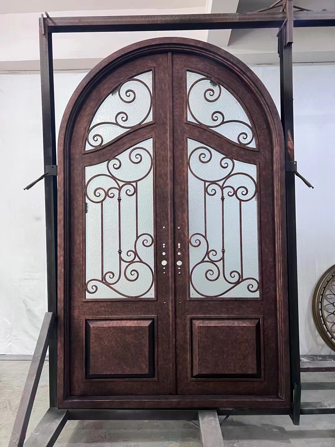 double wrought iron front door in brown color