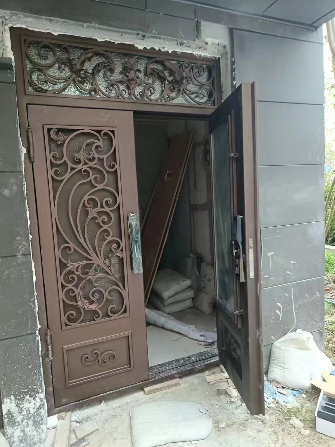 double wrought iron front door in brown color