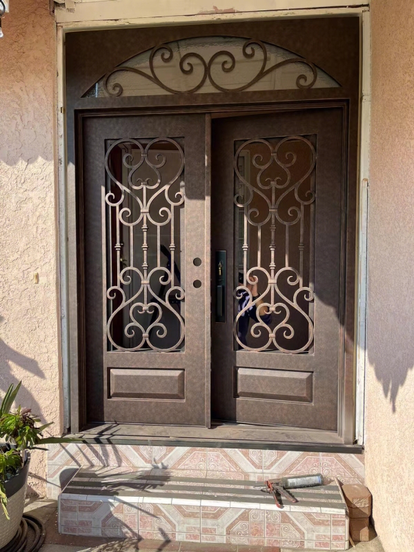 double wrought iron front door in brown color