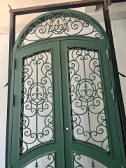 double wrought iron front door in green color