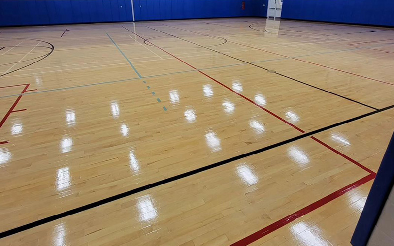 Why do basketball courts use wooden floors?