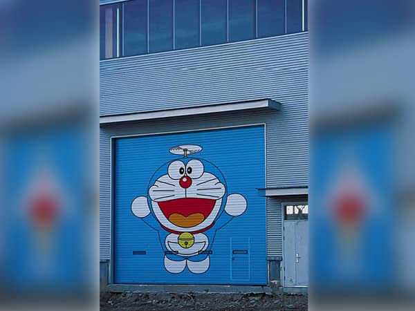 Vertical UV printer print Doraemon cartoon on factory rolling shutter outdoor wall painting