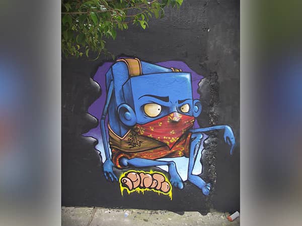 Blue masked hip hop cartoon graffiti printed on grey concrete wall with TXC-WP2500 UV wall printer