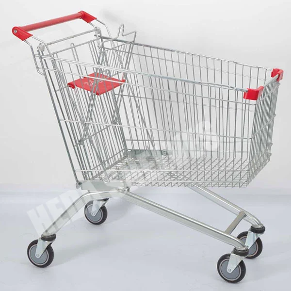 Official HEDA Type B supermarket metal wire shopping cart side view with red push handle, tapered shopping basket, foldable child seat, angled silver tubular chassis and four caster wheels