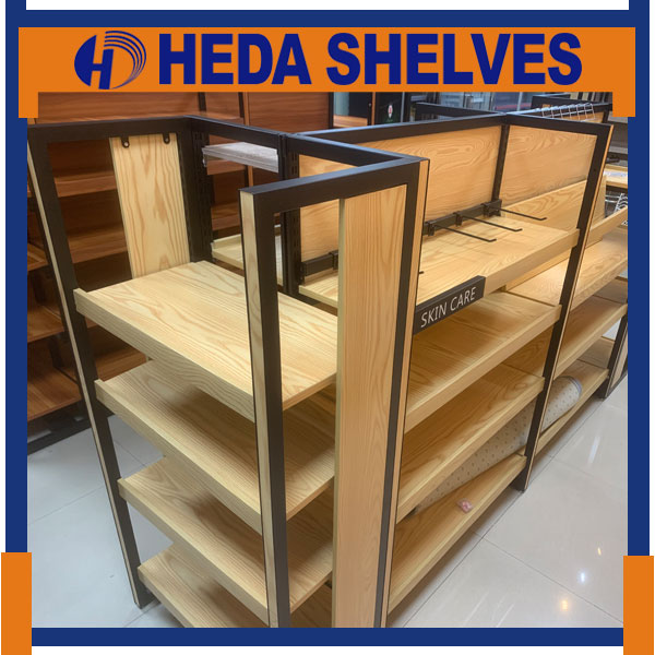 Original HEDA WGRFLS01 wooden gondola retail rack photographed in a showroom, showing black rectangular steel frame, natural wood-grain side panels, multiple wooden display shelves and metal shelf supports